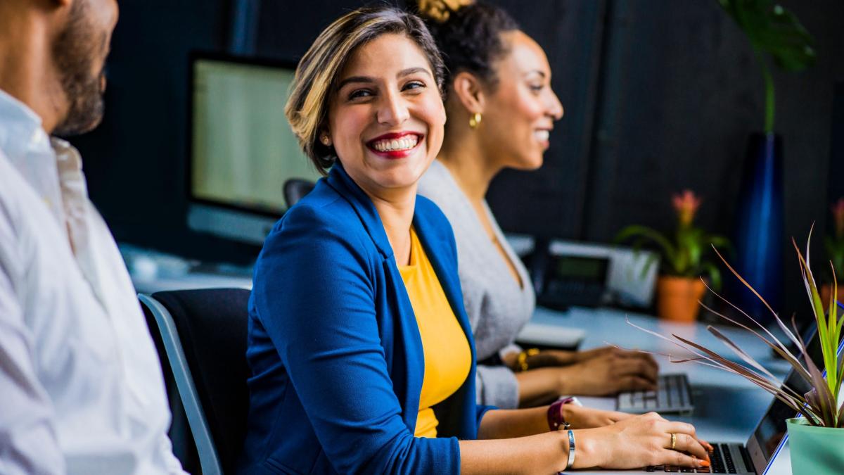 Woman smiling at desk