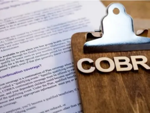 COBRA insurance form on clipboard