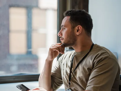 man looking out window