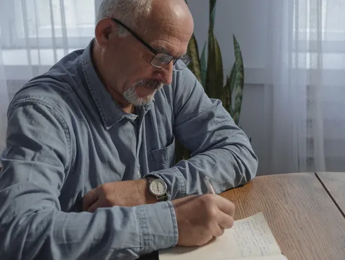 mature male filing out paperwork