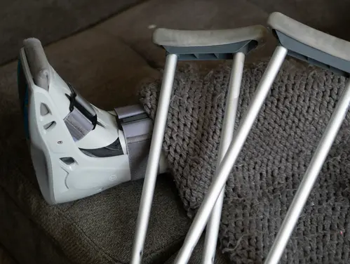 Injured foot in boot with crutches