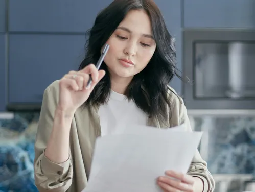 Woman holding a pen and paper