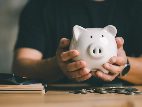 man holding piggy bank