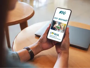 person holding a phone with RIC 457 account on the screen
