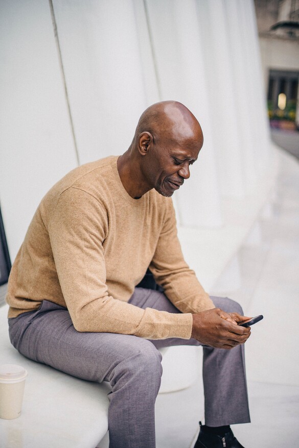 mature man holding phone