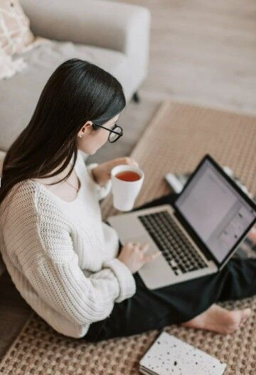 woman on laptop with coffee cup
