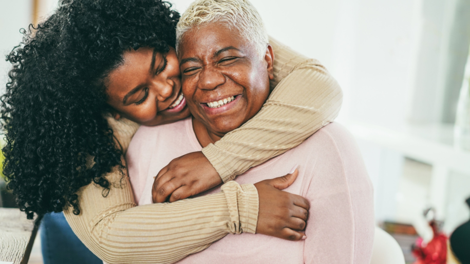 Daughter hugging mom